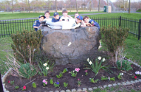 Cub Scout Troop 70 cleaned and planted flowers around the rock at Joe Palaia Park.